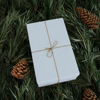 Christmas Wrapping Paper featuring solid winter blue gift wrap made to coordinate with holiday decorations.