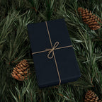 Christmas Wrapping Paper featuring blue angels, ornaments, bows and stars on a deep midnight background.