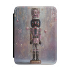 Kindle Case featuring a pink nutcracker with ornaments on a soft purple ombre background.