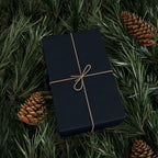 Christmas Wrapping Paper featuring blue angels, ornaments, bows and stars on a deep midnight background.