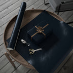 Christmas Wrapping Paper featuring blue angels, ornaments, bows and stars on a deep midnight background.