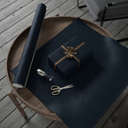 Christmas Wrapping Paper featuring blue angels, ornaments, bows and stars on a deep midnight background.