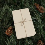 Christmas Wrapping Paper featuring solid cream gift wrap made to coordinate with holiday decorations.