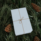 Christmas Wrapping Paper featuring solid winter blue gift wrap made to coordinate with holiday decorations.
