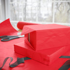Christmas Wrapping Paper featuring solid cheer red gift wrap made to coordinate with holiday decorations.