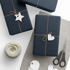 Christmas Wrapping Paper featuring blue angels, ornaments, bows and stars on a deep midnight background.