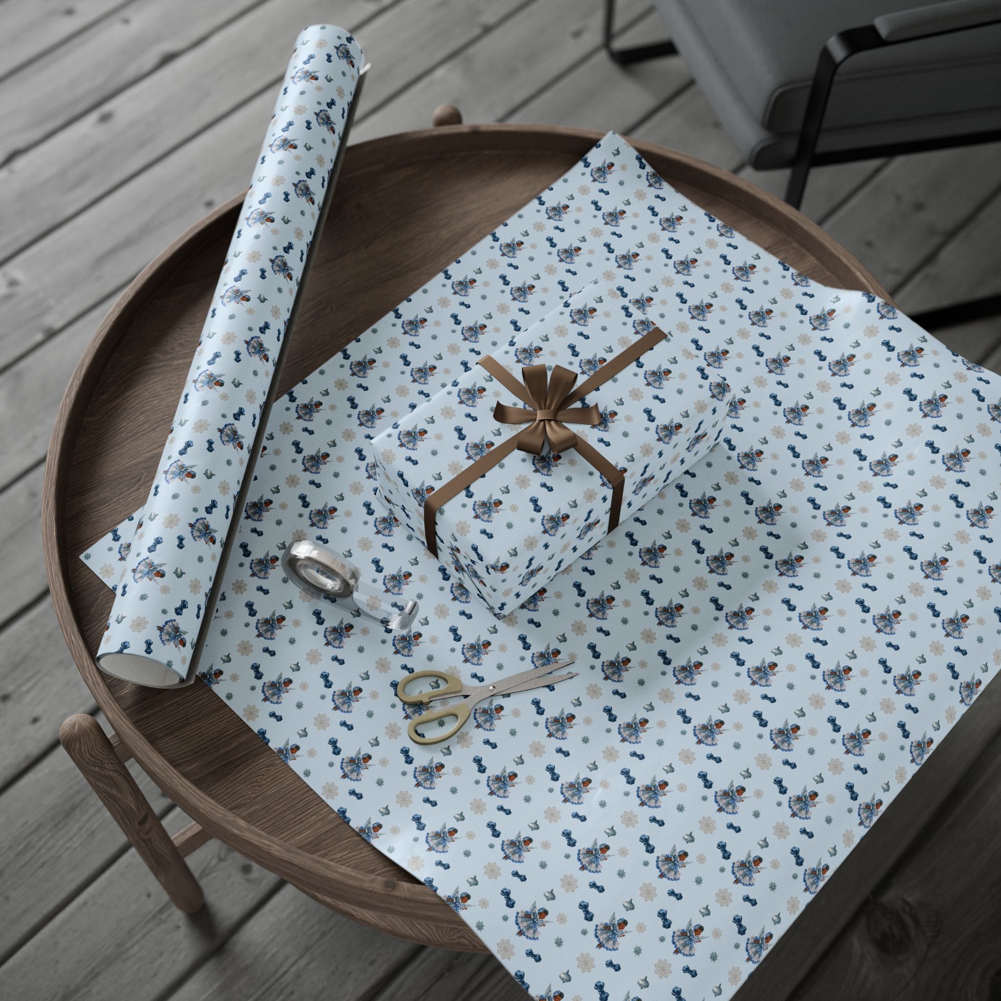 Christmas Wrapping Paper featuring blue angel artwork with soft winter holiday accents.