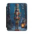 Kindle Case featuring a traditional nutcracker standing near a glowing lantern in a snowy night forest.